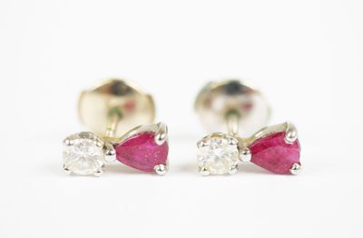 a pair of ruby and diamond earrings on a white background