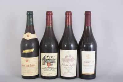 four bottles of wine are lined up on a table