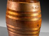 an old wooden barrel sitting on top of a white surface