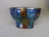 two bowls sitting on a table with a white wall in the background