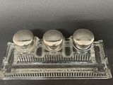 three salt and pepper shakers sitting on a glass tray