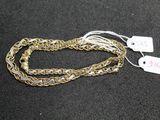 a close up of a gold chain with a tag on it