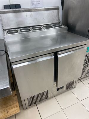 a stainless steel counter top with a microwave on top of it