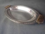 a silver plate with a wooden handle on a table