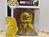 a close up of a box with a gold figurine in it