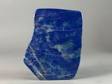 a close up of a blue stone object on a white surface