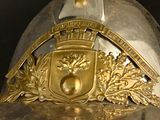 a close up of a helmet with a coat of arms on it