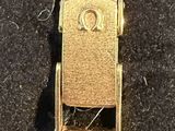 an image of a close up of a gold watch on a black surface