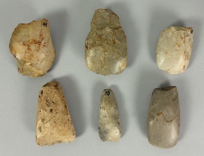 several pieces of stone are arranged in a row on a white surface