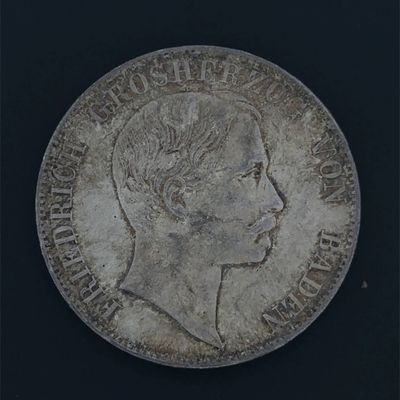 an old silver coin with a woman ' s profile on it