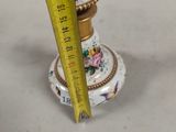 a measuring tape that is on top of a small vase