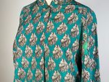 a woman ' s shirt with a floral pattern on it