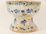 a blue and white bowl sitting on a white surface
