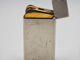 a close up of a silver lighter with a lighter in it