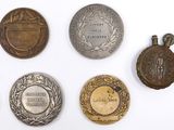 several medals are displayed on a white surface with a white background