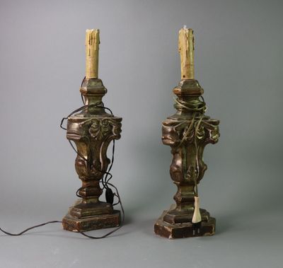 pair of antique brass table lamps with candles on top of them