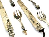 many different types of silverware on a white surface