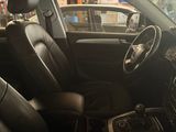 the interior of a car with black leather seats and steering controls
