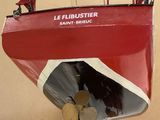 a red boat with a propeller attached to it ' s hull