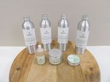 bottles of skin care products on a wooden tray on a table