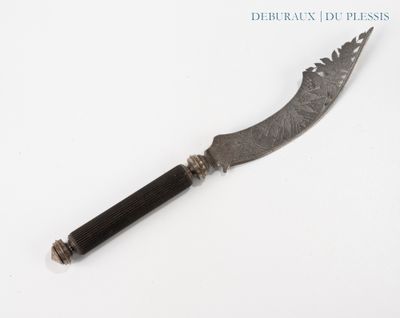a knife that is laying on a white surface