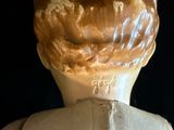 a close up of a statue of a person with a hat on