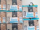several packages of baby diapers sitting on top of a white table
