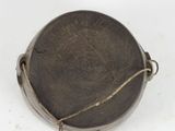 a small metal object with a rope on it