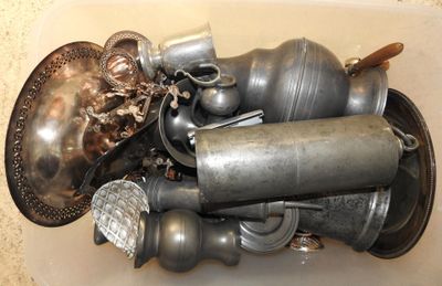 a white container filled with silver objects on a counter