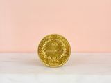 an image of a gold coin sitting on top of a marble counter