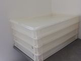 a stack of plastic containers sitting on top of a table