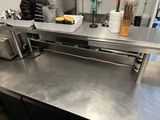 stainless steel counter top in a commercial kitchen with dishes and utensils on it