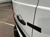 a white van parked in a parking lot with a sticker on the door