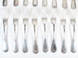 a lot of forks and spoons on the table