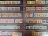 many different types of stamps on display in a glass case