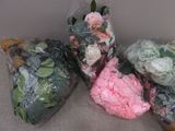 many different types of flowers wrapped in plastic bags