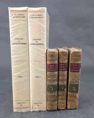 three books are stacked on top of each other on a table