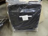 a black shirt wrapped in plastic sitting on a table