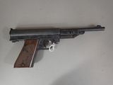 a gun that is sitting on a table with a key in it
