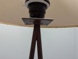 a lamp that is on top of a wooden stand