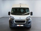 the front of a white van is parked in a large room