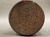 a wooden object with carvings on it on a table