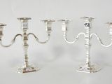 two silver candelabs with numbers on each of them