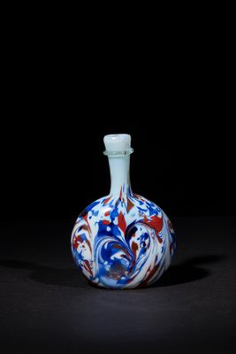 an image of a blue and white vase on a black surface