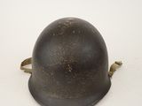 an old helmet is sitting on a white surface with a white background