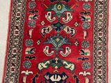 a red and blue rug with a design on it