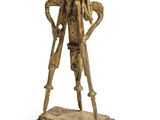 an image of a bronze statue of a woman holding a cane
