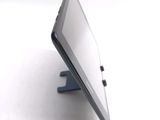 a tablet computer sitting on a stand on a table
