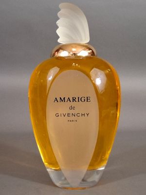 an image of a bottle of perfume with a white feather on top