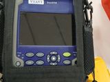 a blue and black handheld computer sitting on top of a black case